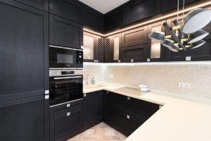 Beautiful luxury kitchen with white marble counters and black cupboards
